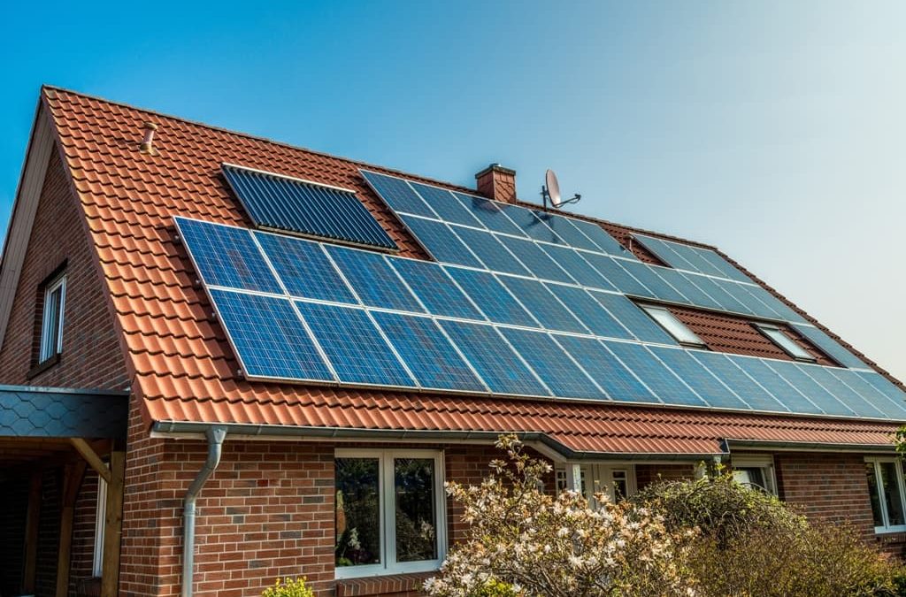 Casa com painéis solares no telhado ilustra post sobre aquecimento solar da água