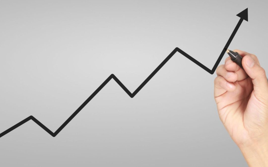 Mão desenhando linha de gráfico em zigue-zague com tendência de alta, representando crescimento e investimentos bem-sucedidos. Imagem ilustrativa para post sobre as melhores cidades para investir no ES, com Nova Venécia entre elas, do blog da Soma Urbanismo.